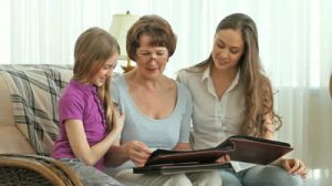 stock-footage-females-of-three-family-generations-looking-through-photo-albums